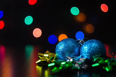 Christmas ball decoration on the table with multicolored bokehの写真素材