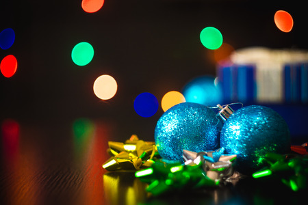 Christmas ball decoration on the table with multicolored bokehの写真素材