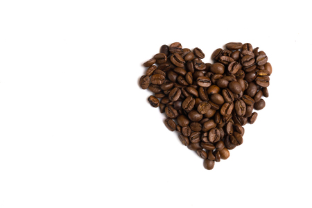 Heart made of coffee beans top view. Love coffee background isolated.の写真素材