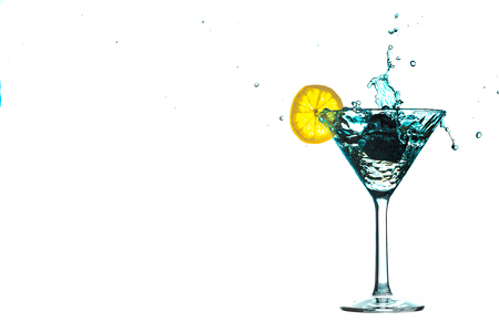 Blue cocktail water drink splash in the glass with lemon Isolated on white backgroundの写真素材
