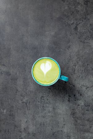 Matcha Latte with latte art on grey background with negative space top viewの写真素材