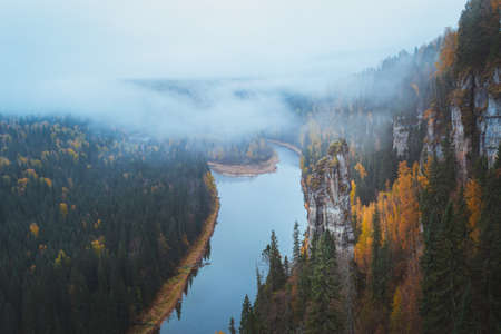 Morning autumn fog over Usva River and Stone Pillar of Perm Region, Russia. High quality photoの写真素材