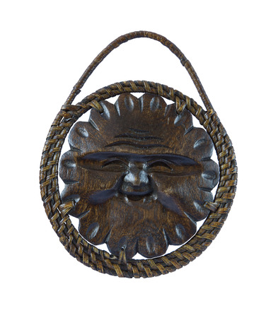 Wooden mask of the sun isolated on white. The decor on the wallの写真素材