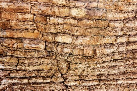 The surface of the rock with horizontal lines with a crack. Stone background.の写真素材