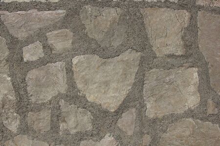 The texture of the walls made of stones bonded with cement.の写真素材
