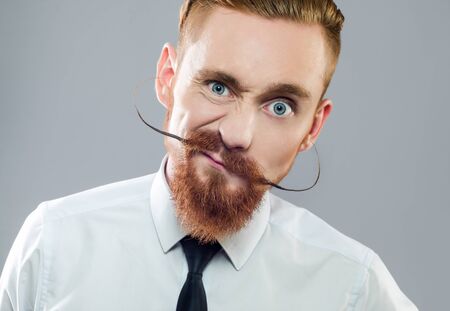 stylish the guy with the beard shows emotionsの写真素材