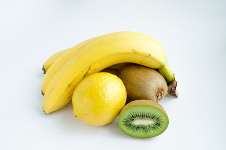 Fruit still life, bananas, lemon and Kiwi, isolated white of background.の写真素材