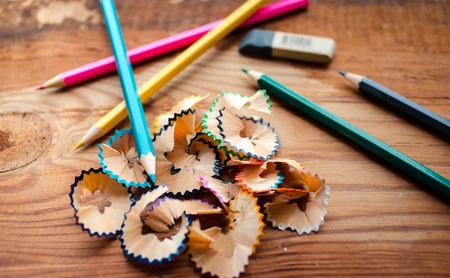 Colored pencils on a wooden board background.の写真素材