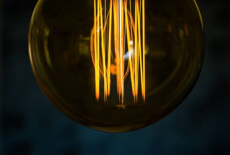 Beautiful women hand on Edison type bulbsの写真素材