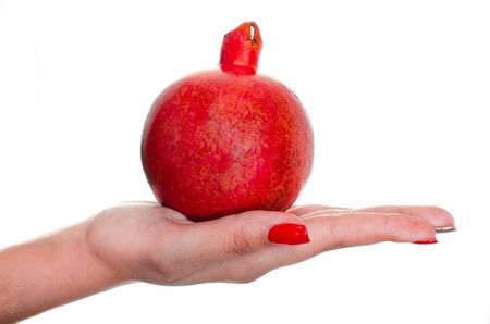 fresh ripe pomegranates in hand on white isolated backgroundの写真素材