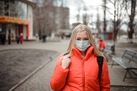 Woman wearing a mask on the street. Protection against virus and gripの写真素材
