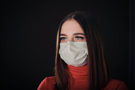 Flu cold or allergy symptom. Sick young woman sneezing in mask isolate on black background. Health...