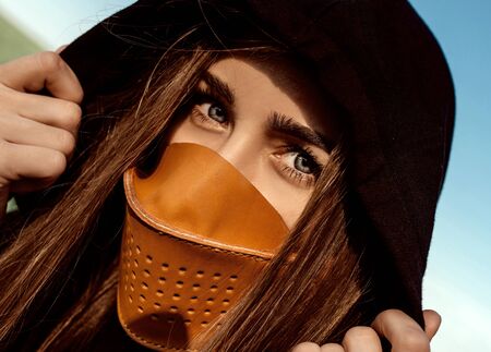 Portrait of a girl in a handmade leather mask, leather craft.
