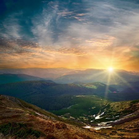 majestic mountain sunset and colored sky with cloudsの写真素材