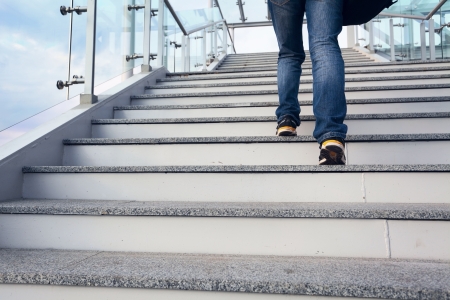 man on office stairs and blue sky, legs closeup