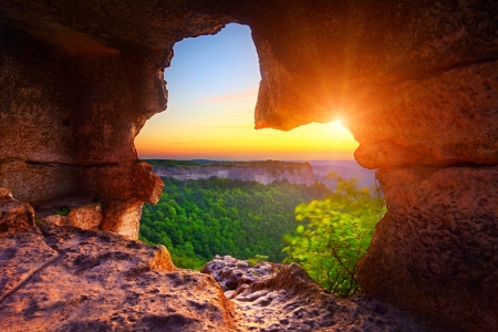 cave and view of canyon at sunset timeの写真素材