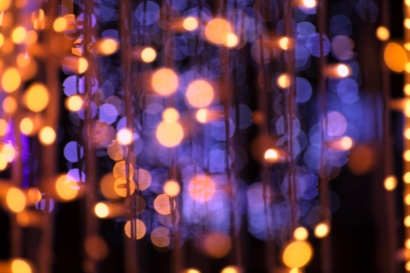 christmas garland blurred lights background with golden and violet colorsの写真素材