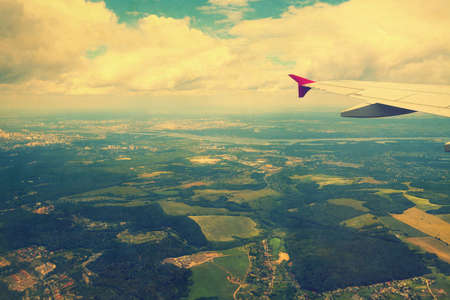 View from airplane window on fields and cities, image in retro colorsの写真素材