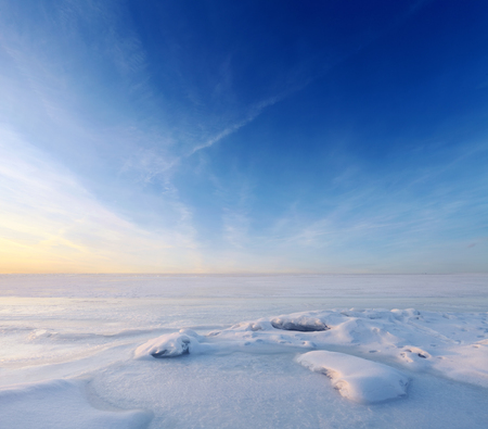 Endless frozen sea water and blue sky over horizon. Landscape at winter seasonの写真素材