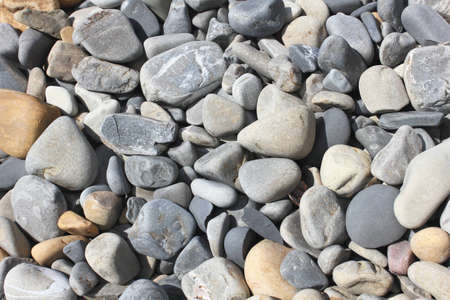 Pebbles on sea coast, pebble background.の写真素材
