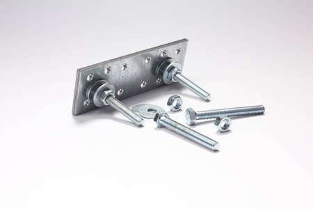 Construction of bolts, nuts, washers and plates on white background.の写真素材