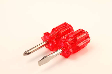 Two small screwdrivers with red handles on white background.の写真素材
