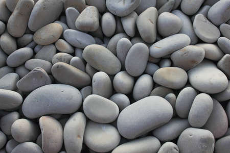 Pebble background, gray pebbles on sea coastの写真素材
