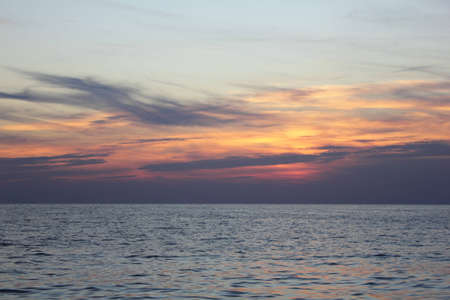 Sun down in the calm sea の写真素材