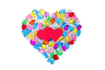 Heart shape made of colored transparent stonesの写真素材