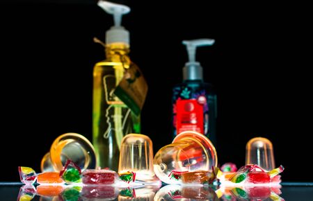 Massage jars and massage gel on a dark background