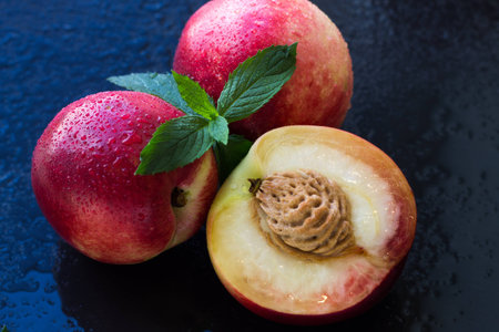 Fresh peaches over dark blue background. Top view.の写真素材