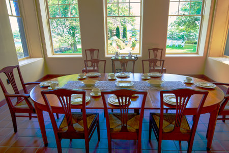 Dining room with red chairs and tablecloths on the tableの写真素材