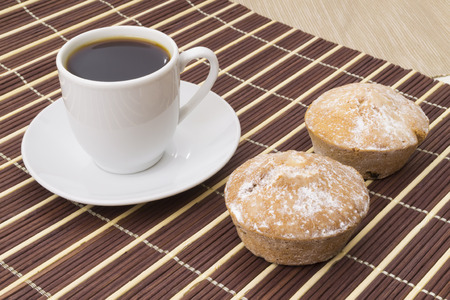 Cup of coffee and two cakesの写真素材