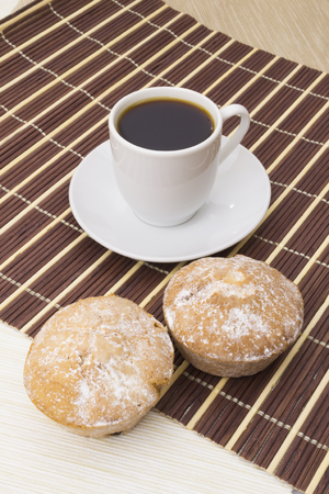 Cup of coffee and two cakesの写真素材