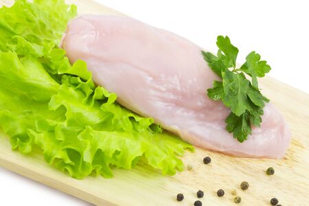 Chicken breast on a cutting boardの写真素材