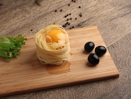 Fettuccini nests with eggの写真素材