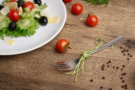 Fresh vegetables salad with tomatoes , olives , parmesan cheeseの写真素材