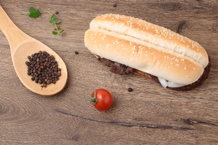 baguette with meat cutlets with onion and a spoon with pepperの写真素材