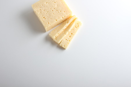 cheese cut into white backgroundの写真素材