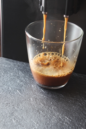 coffee glass on a stone background coffee machineの写真素材