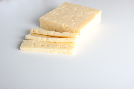 cheese cut into white backgroundの写真素材