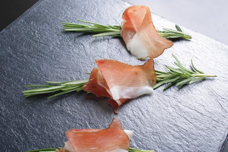 prosciutto, jamon on a stone backgroundの写真素材