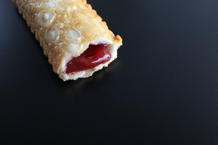 cherry pie Oil fried wild berries jam on a black background