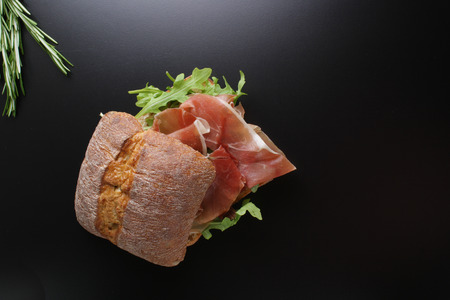 sandwich with prosciutto jamon on a stone backgroundの写真素材