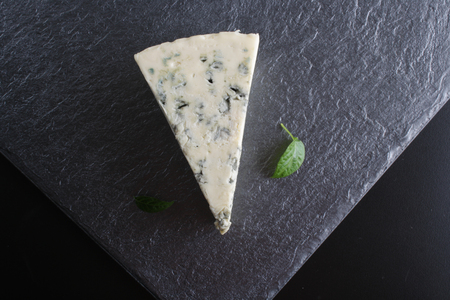 blue cheese on a stone background blackの写真素材