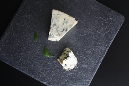 blue cheese on a stone background blackの写真素材