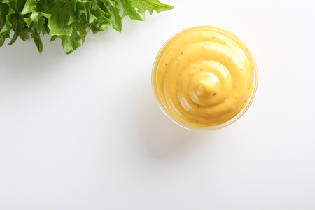 mustard sauce on white backgroundの写真素材