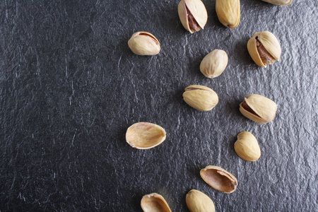 pistachios on a dark stone backgroundの写真素材