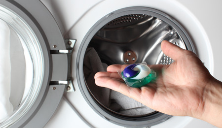 detergent capsule washing machine handの写真素材