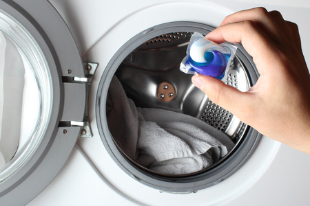 detergent capsule washing machine handの写真素材